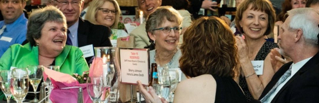 Image of Guests at the 2018 Tuxedo Cat Ball Gathered Around a Table