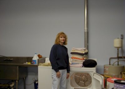 1999 - Volunteers Martha Benton in kitchen laundry of new shelter